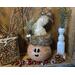 This shows a Christmas gourd decoration. It is made to look like an elf, with a custom sherpa hat and winter decorations.